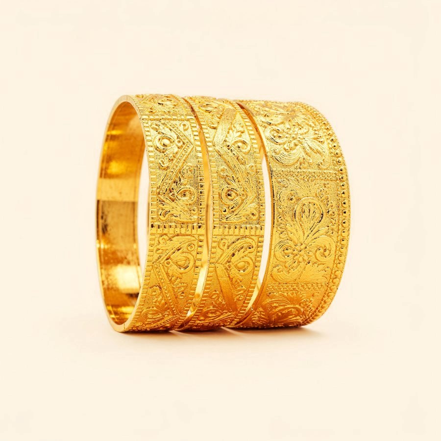 A stack of engraved 916 yellow gold bangles