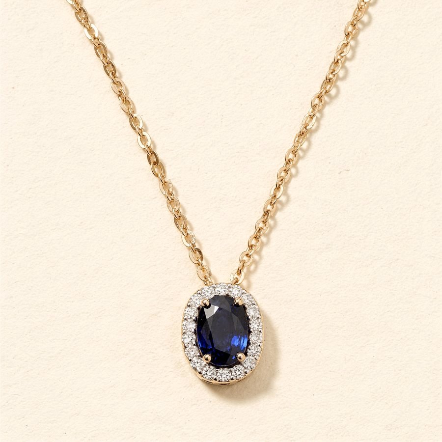 Gold chain necklace with a sapphire and diamond pendant